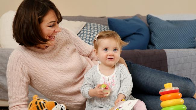 Alex Martin plays with one-year-old daughter, Holly, at their Bondi home. She has been overwhelmed with support by admits single parenthood can sometimes be a lonely path and not without struggles. Picture: Jonathan Ng