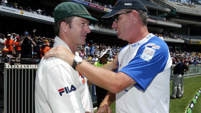 Jones shakes hands with fellow cricket legend Steve Waugh.