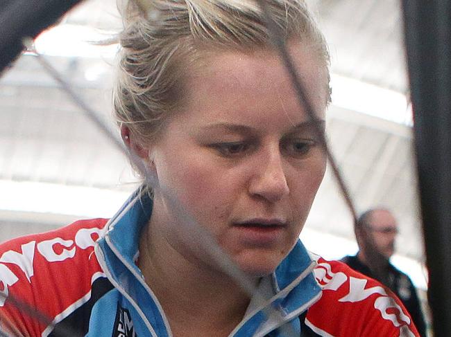 Track cyclists in various locations. Stephanie Morton changes the wheel on her bike at the Superdrome. Photo Sarah Reed.