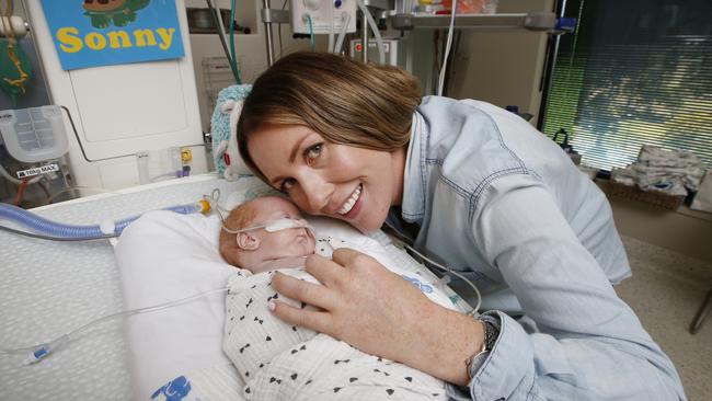 Sonny is hugged by his mother Kimberley. Picture: David Caird