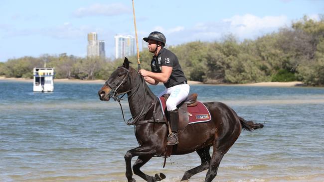 Polo by the Sea player Andrew Fraser-Scott with polo horse Prodigy at the Spit. Picture Glenn Hampson