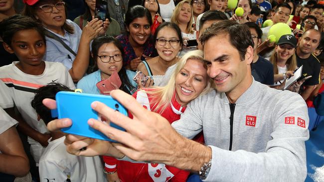 Federer poses for selfies with fans after a practice session in Perth. Picture: Getty Images