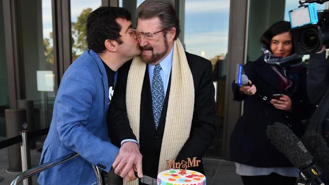 Labor Senator Sam Dastyari kisses independent Senator Derryn Hinch after cutting a Marriage Equality Cake at the Senate doors at Parliament House in Canberra on Thursday. Picture: AAP