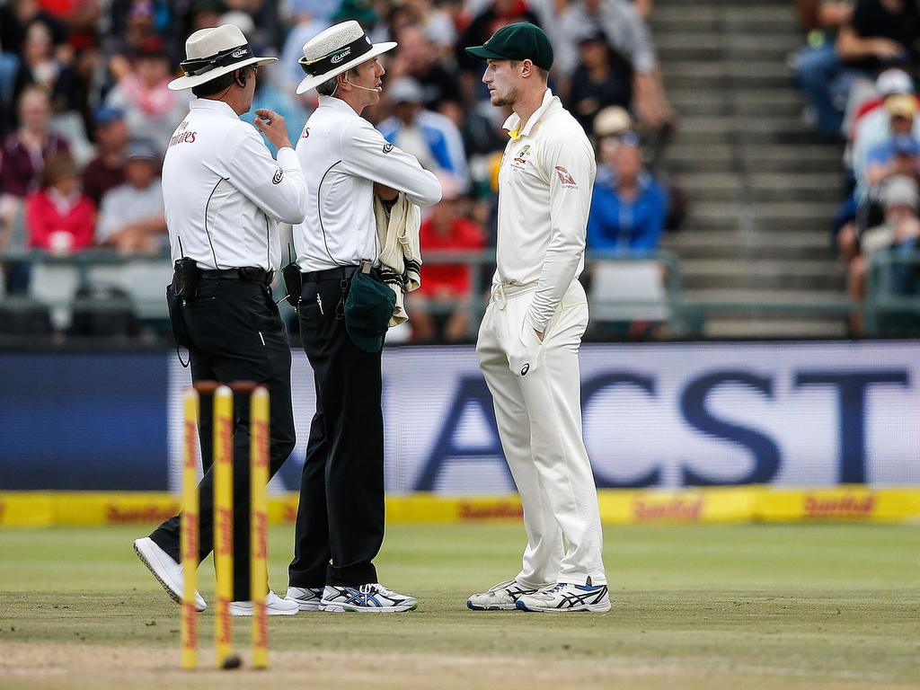 Umpires speak to Cameron Bancroft (R) in Cape Town. Picture: AFP/Gianluigi Guercia