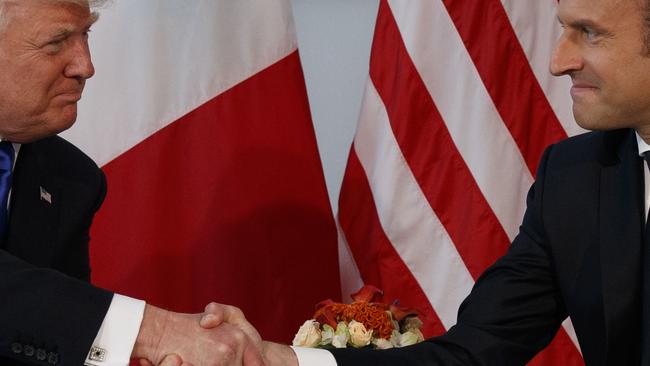 President Donald Trump shakes hands with French President Emmanuel Macron during a meeting at the U.S. Embassy in Brussels. Picture: AP