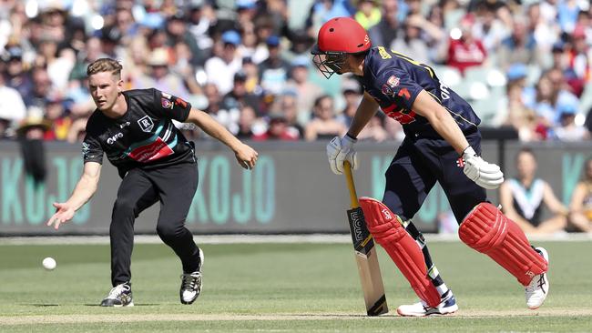 Adelaide’s Paul Seedsman falls over and finds himself about to be run out by Port Adelaide’s Kane Farrell. Picture: Sarah Reed