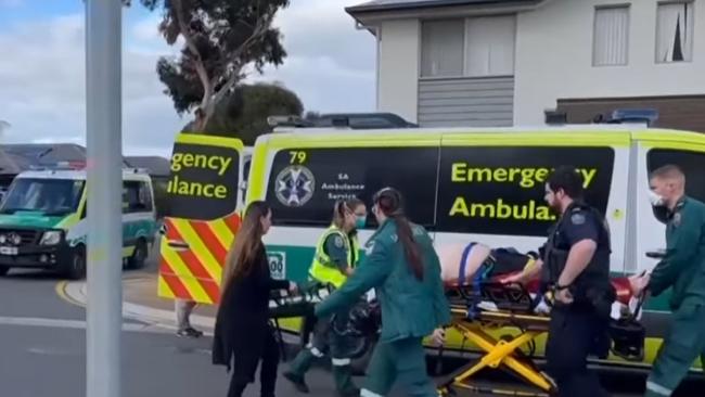 Paramedics with the man injured in the hit-run at Andrews Farm. Picture: 7NEWS