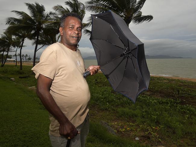 Jordan Rajadurai braves conditions on The Strand as Tropical Cyclone Kimi sits off the coast. PICTURE: MATT TAYLOR.