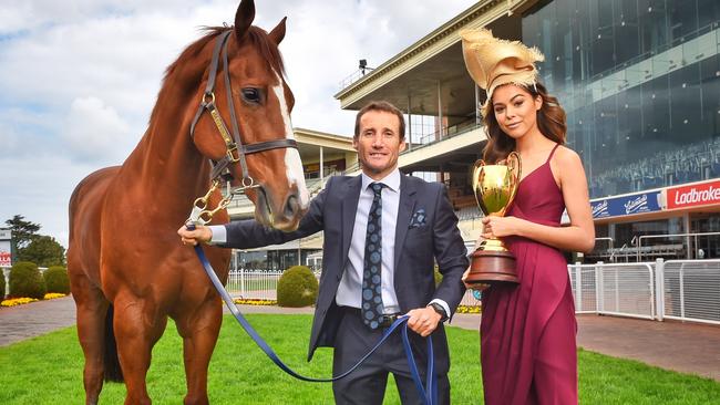 Jockey Damien Oliver with racehorse, Hero and Elissa from Vivien's Model Management with the Caulfield Cup at the Caulfield Race Track. Picture: Tony Gough