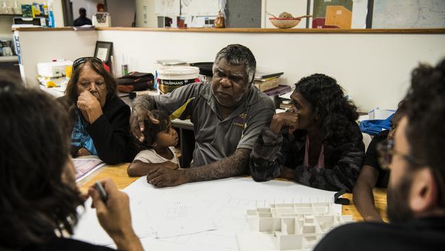 Local elders including Patricia Frank Nururula and Norm Frank Jupurrurla look over plans designed by Simon Robinson and Steve Mintern from Office, a not-for-profit multidisciplinary design and research practice based in Melbourne, for the Wilya Janta Housing Collaboration project inside Tennant Creek’s Nyinkka Nyunyu Art and Culture Centre. Picture: Andrew Quilty/Climate Council