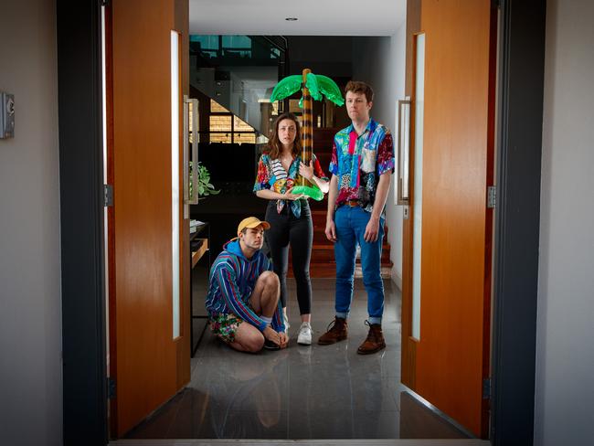 The 91-Storey Treehouse cast members Sam Welsh, Rebecca Rolle and Teale Howie at the front door of house at Tennyson where they have been in isolation for two weeks.