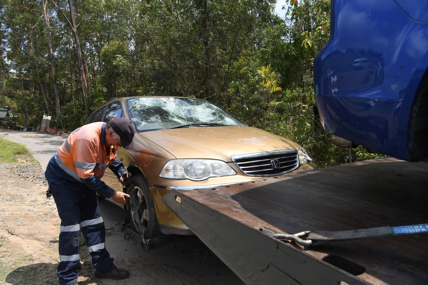 Cleaning up after the Sunday storm on the Sunshine Coast Coast. Cars are towed away in Palmview from hail damage.