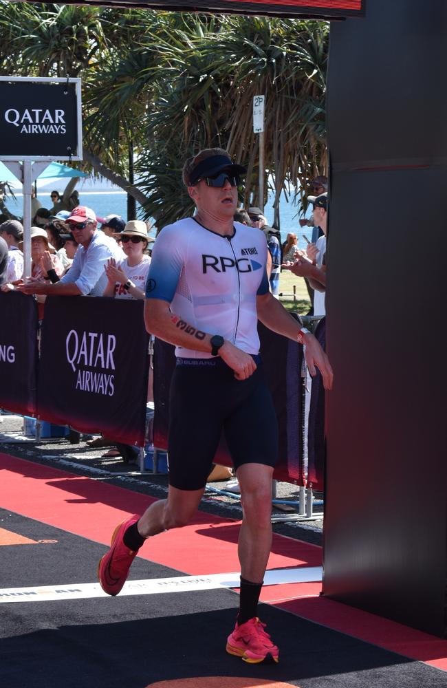 Athletes crossing the finish line at Sunshine Coast Ironman 70.3 2023.