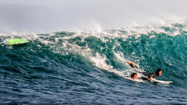 16/04//2018: A surfer helps a fellow board rider (L) who has just been attacked by a shark in Gracetown, Western Australia. PIC: Peter Jovic for The Australian