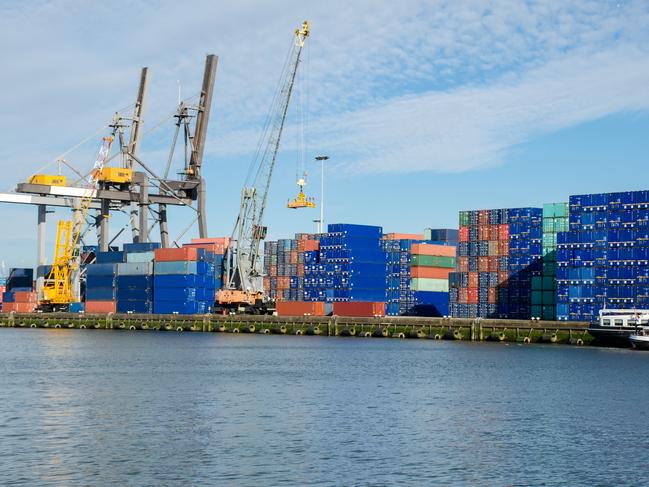 Industrial cranes loading containers at the Port of Rotterdam.