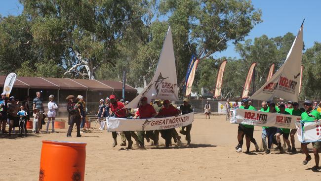 Teams raced around empty barrels on a dry Todd River in the KFC Maxi Yacht race. Picture: Laura Hooper.