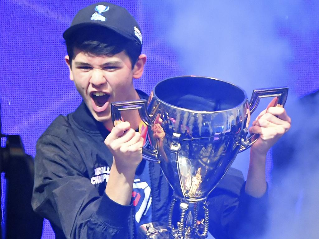 Bugha of the US celebrates with the trophy after winning the final of the Solo competition at the 2019 Fortnite World Cup July 28, 2019 inside of Arthur Ashe Stadium, in New York City. (Photo by Johannes EISELE / AFP)