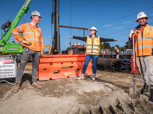 Senior Safety officer Michelle Adams checks distancing with workers Simon Bray and Mick Lonie at a level crossing construction site in Cheltenham. Picture: Jake Nowakowski