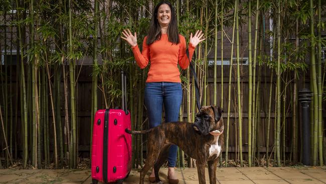 Sahra Connor, a South Australian living in Melbourne, is happy that she can travel to Adelaide with her dog Tiger Lily now that the borders are about to reopen. Picture: Jake Nowakowski