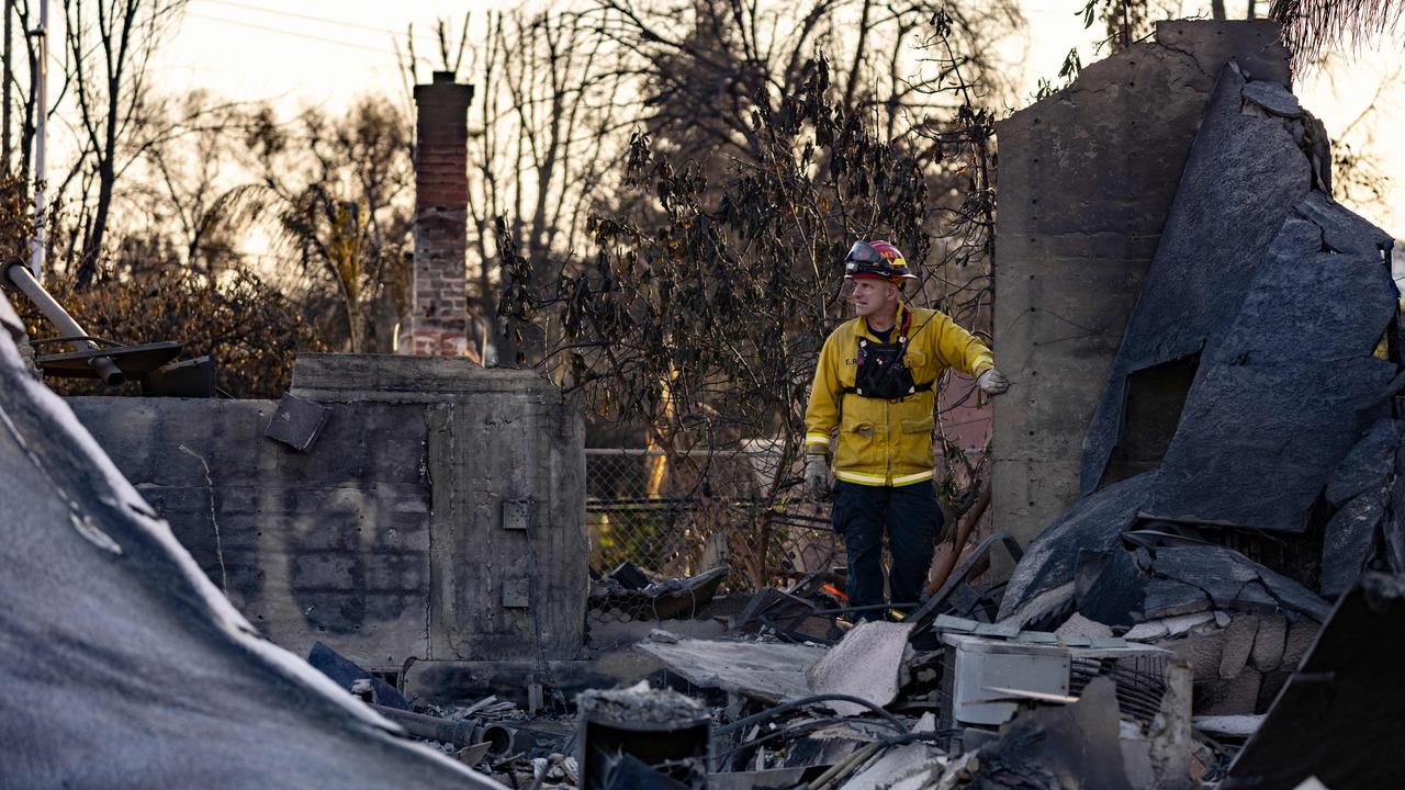 A firefighter walks among the remains of a house reduced to rubble by the Eaton fire. Picture: AFP