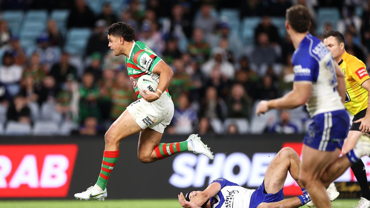 SYDNEY, AUSTRALIA - JULY 17: Latrell Mitchell of the Rabbitohs beats the tackle of Matt Burton of the Bulldogs as he breaks away to score a try during the round 18 NRL match between the Canterbury Bulldogs and the South Sydney Rabbitohs at Stadium Australia, on July 17, 2022, in Sydney, Australia. (Photo by Mark Kolbe/Getty Images)