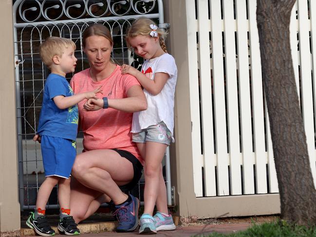 Bethan Freeman checks her fitbit with her kids Annabelle, 6, and Rhys, 3 at their home in Goodwood. Bethan Freeman is taking part of a study which tracks her activity and weight each day for a year. Photo Kelly Barnes