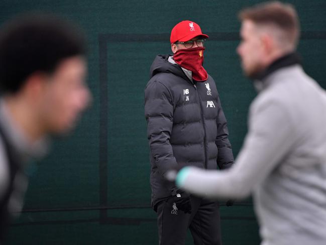 (FILES) In this file photo taken on March 10, 2020 Liverpool's German manager Jurgen Klopp watches his players attend a training session at Melwood in Liverpool, north west England, on the eve of their UEFA Champions League last 16 second leg football match against Atletico Madrid. - English Premier League clubs voted unanimously on May 27, 2020 to resume contact training as the English top-flight took a significant step towards a possible restart in June. The Premier League was put on hold in March due to the coronavirus pandemic, with Liverpool agonisingly close to the title. Clubs returned to training in small and socially distanced groups last week but they have now moved to stage two of the 