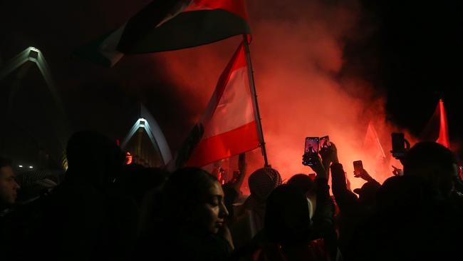 Palestine supporters ignite flares during a rally outside the Sydney Opera House on October 09. Picture: Lisa Maree Williams/Getty Images)