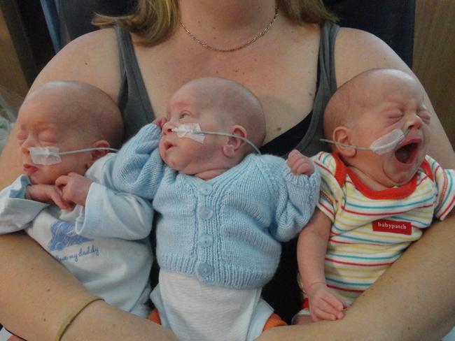 Triplets Grayson, Tiernan and Leon McGregor have their first cuddle with mum Laurelea, December 2012 — aged about a month.