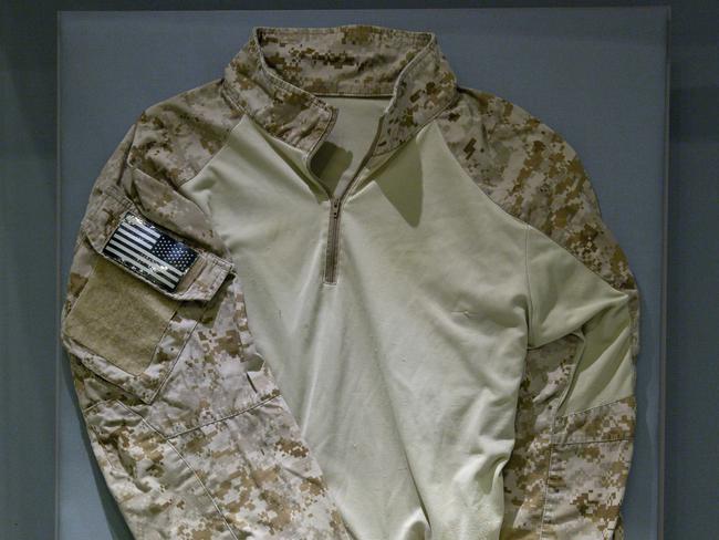 Artefact ... The fatigue shirt worn by Navy SEAL Robert O'Neill during the mission to capture Osama bin Laden in a case at the 9/11 museum in New York. Picture: Jin Lee/AP
