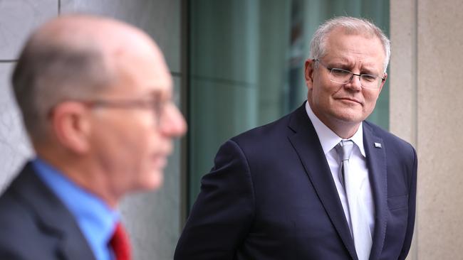 Australian Prime Minister Scott Morrison (right) listens to Acting Chief Medical Officer Paul Kelly speak during a media conference at Parliament House in Canberra in September. Picture: Getty Images