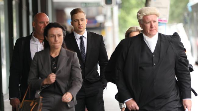 Kyle Daniels pictured (centre) outside Downing centre courts on the first day of his trial. Picture: NCA NewsWire / Damian Shaw