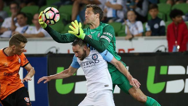 Melborune City goalkeeper Thomas Sorensen climbs over teammate Josh Rose to claim the ball on Saturday night. Picture: George Salpigtidis