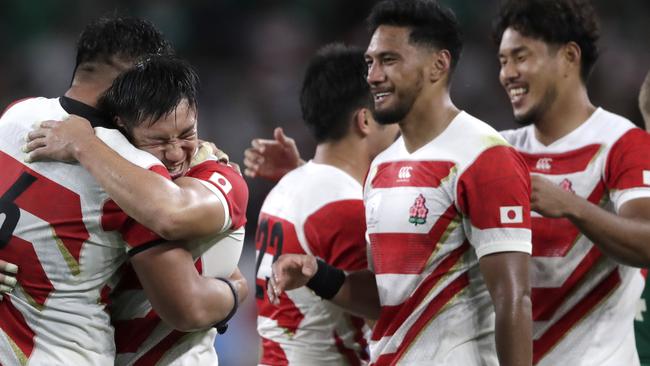 Japanese players celebrate after winning their Rugby World Cup Pool A game 19-12 at Shizuoka Stadium Ecopa against Ireland in Shizuoka, Japan, Saturday, Sept. 28, 2019. (AP Photo/Jae Hong)