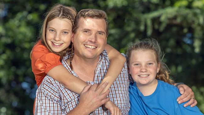 Ryan Harris, with his daughters Matilda and Violet, says he has not been the same since the Black Summer bushfires. Picture: Gary Ramage