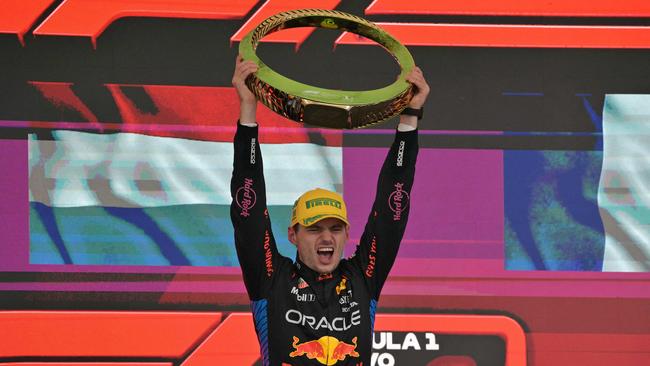 Max Verstappen raises the trophy after winning the Brazil Grand Prix