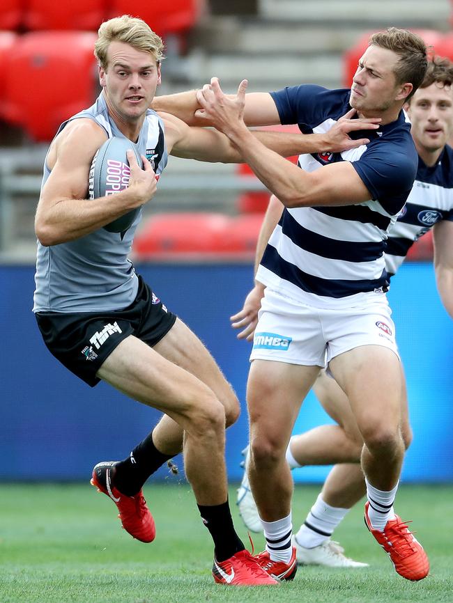 Power recruit Jack Watts fends of Mitch Duncan. Picture: Calum Robertson