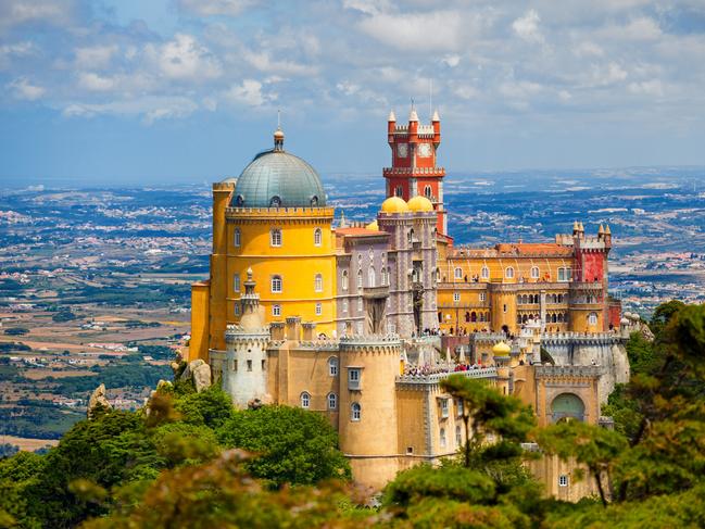 ESCAPE: 48 hours in Lisbon, Alana Schetzer, Sunday Escape -  Sintra, Portugal - July 5, 2012: Panorama of Pena National Palace above Sintra town at a summer day. Visible some unrecognizable people in the rooftops  Picture: Istock