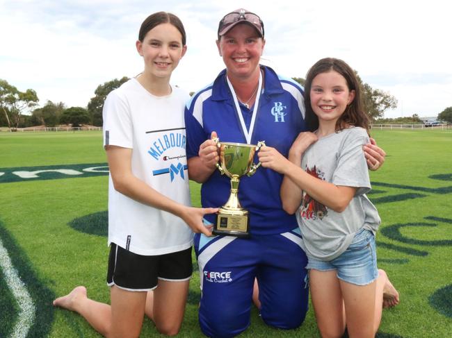 Kat Paton-Hodges holds Barwon Heads' A-grade premiership cup with daughters Zoe and Maddi. Picture: Meg Saultry