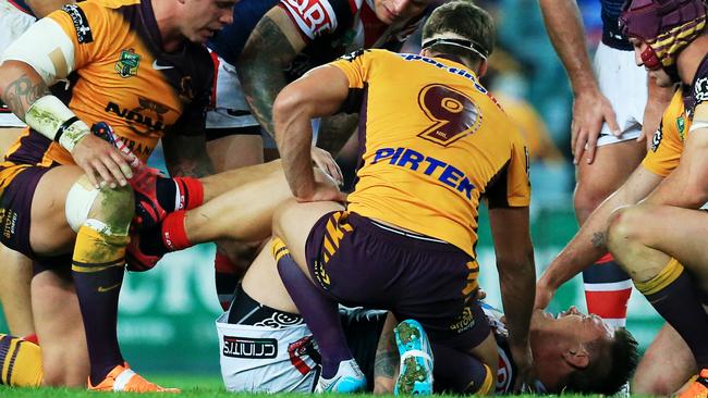 Roosters and Broncos players all stop as Waerea-Hargreaves goes down.