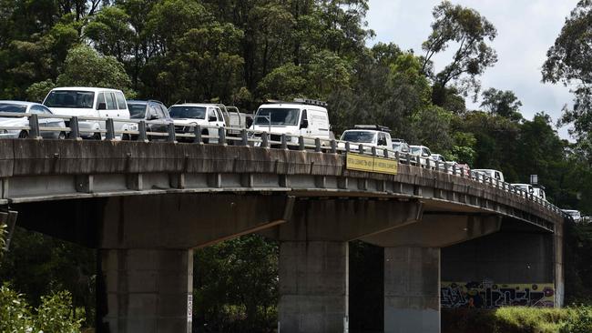 GOLD COAST, AUSTRALIA - NewsWire Photos DECEMBER 15 2020: Local at Tumbulgum park their cars on high ground on the bridge as flooding and wild weather battered south-east Queensland and north-east NSW. Picture: NCA NewsWire / Steve Holland