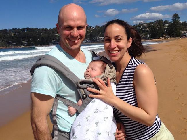 Melanie Fentoullis and Sinclair Barry, pictured with their 10-week-old son Henry, at North Avoca beach.