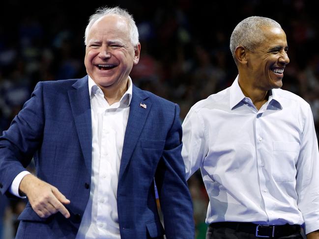 Former US President Barack Obama (R) smiles next to Minnesota Governor and Democratic vice presidential candidate Tim Walz after speaking during a campaign rally in support of Vice President and Democratic presidential candidate Kamala Harris, at Alliant Center in Madison, Wisconsin, on October 22, 2024. (Photo by KAMIL KRZACZYNSKI / AFP)