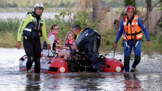 Kyle Eggins and his family being evacuated from their Gulmarrad property. Picture: Toby Zerna.