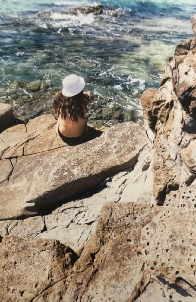 Alyssa Postle sitting on the rock at Mooloolaba before she was killed in a car crash.