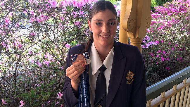 Mt St Michael’s alumni Meg Harris, of St Peters Western with her world junior championship medals.