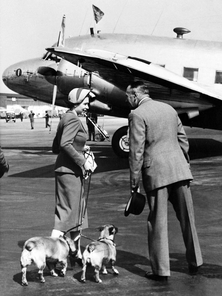 The Queen and her dogs board a plane in London in 1953. Picture: AFP