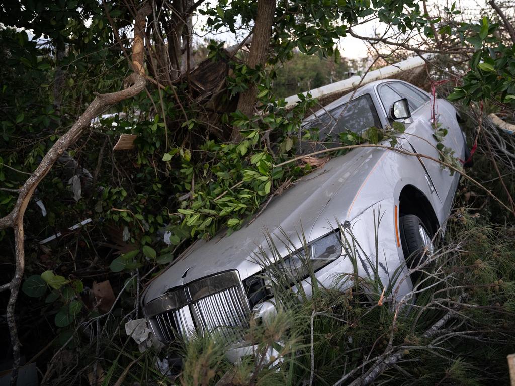 A Bentley rests against a tree in the wake of Hurricane Ian in Bonita Springs, Florida. The category four storm made a U.S. landfall on Wednesday. Picture: Sean Rayford/Getty Images/AFP