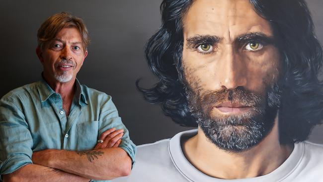 Artist Angus McDonald with his portrait of Behrouz Boochani at the Art Gallery of NSW in Sydney. Picture: Gaye Gerard