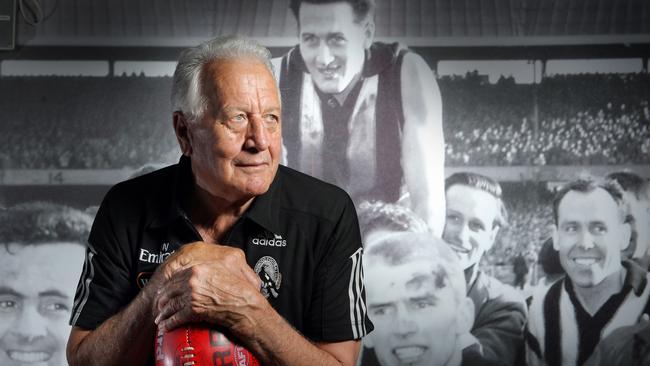 Murray Weideman in front of an older photograph of himself being carried off the footy ground, as captured by Alex Coppel in 2009. Sadly, Weideman died in 2021.